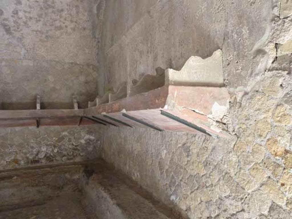 VI.1/7. May 2010. Looking towards south-east corner, with shelving for clothing and articles and bench below.